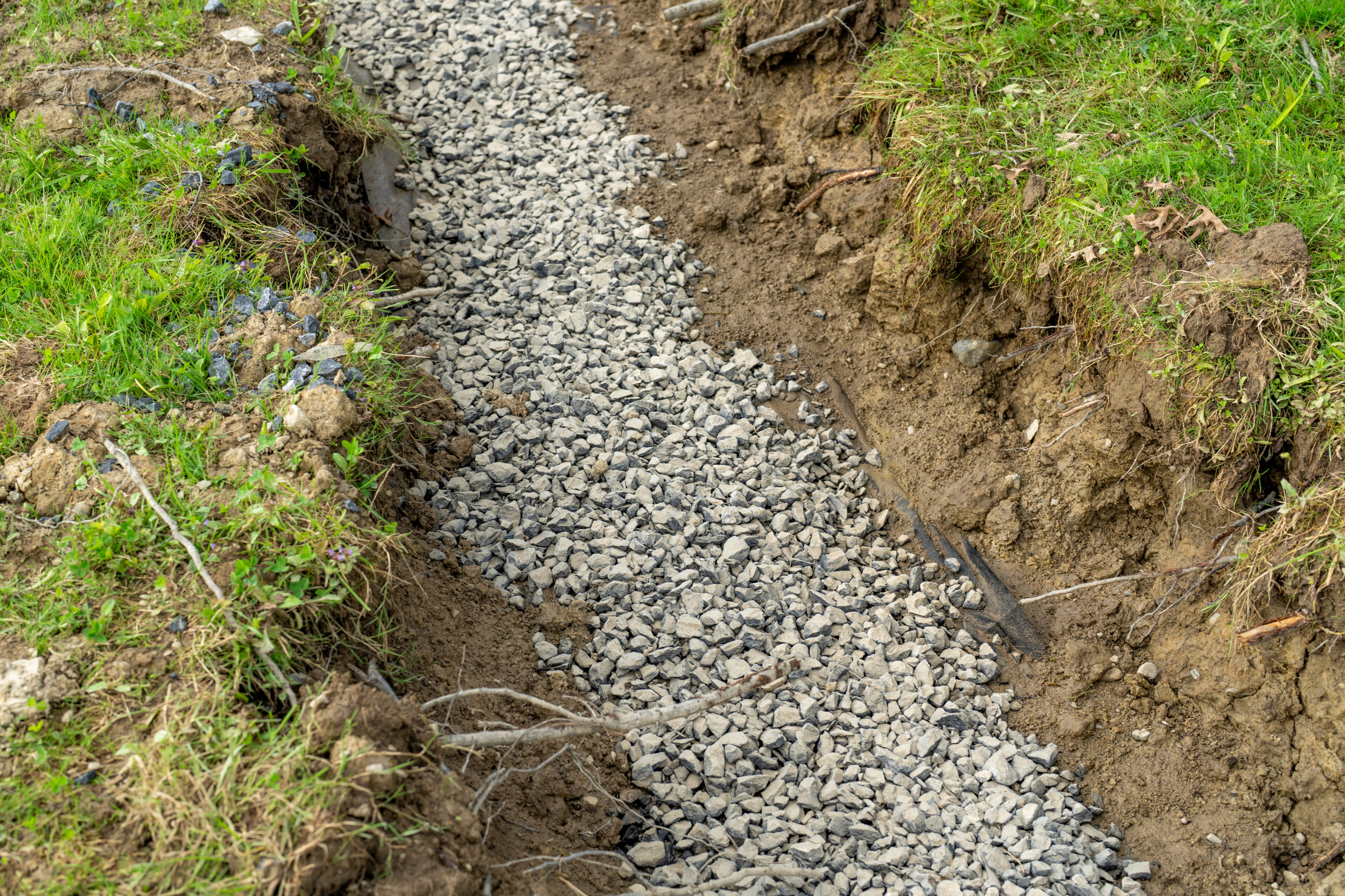 Stone French drain, under drain to mitigate storm water ground water. Stone French drain, under drain to mitigate storm water ground water.
