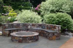 Stone fire pit with curved seating area.