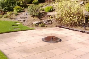 Garden with paved area and sundial centerpiece.