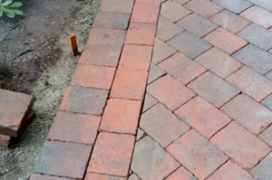 Red brick walkway under construction.