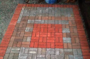 Multicolored brick patio with geometric pattern.