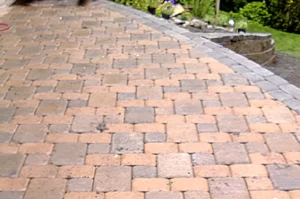 Brick patio with stone border and garden.