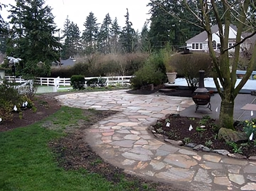 Stone pathway in a landscaped backyard garden.
