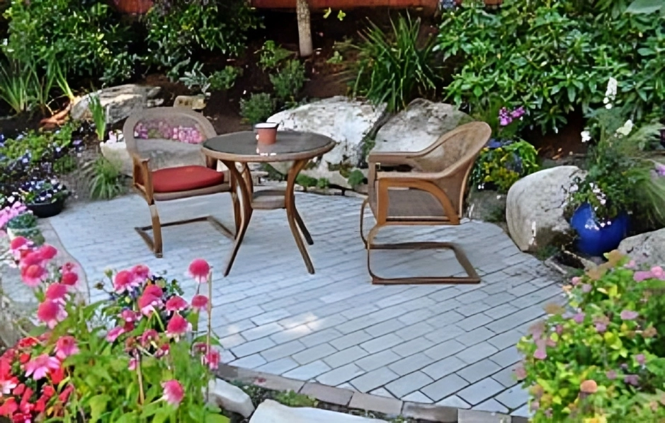 Garden patio with chairs and table.