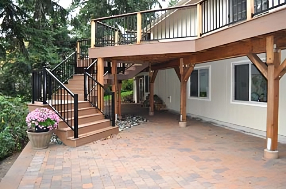 Two-story deck with wooden staircase.