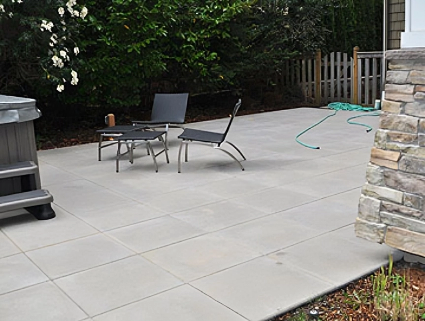 Patio with chairs and garden hose.