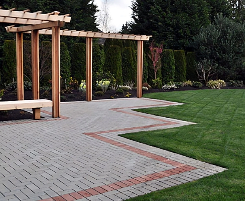 Garden path with wooden pergola and lawn.