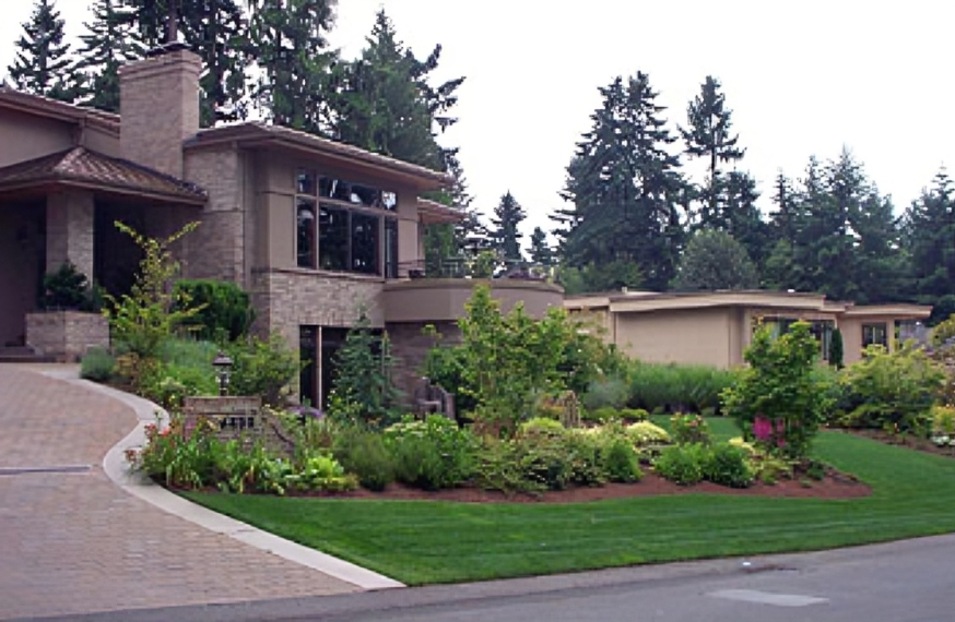 Modern house with landscaped front yard. Modern house with landscaped front yard.