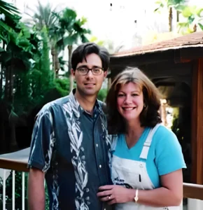 Smiling couple posing in tropical garden setting. Smiling couple posing in tropical garden setting.