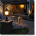 Warmly lit entrance with garden path.