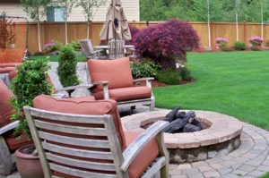 Backyard patio with chairs and fire pit.