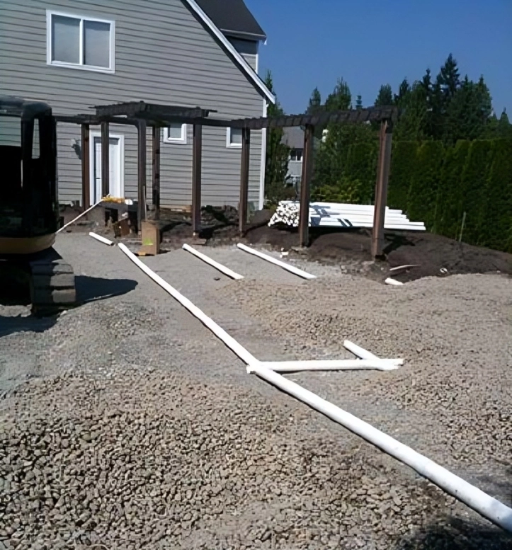 House construction site with white PVC pipes.