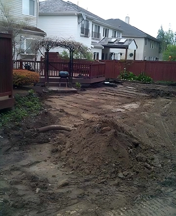 Backyard under construction with dirt piles.