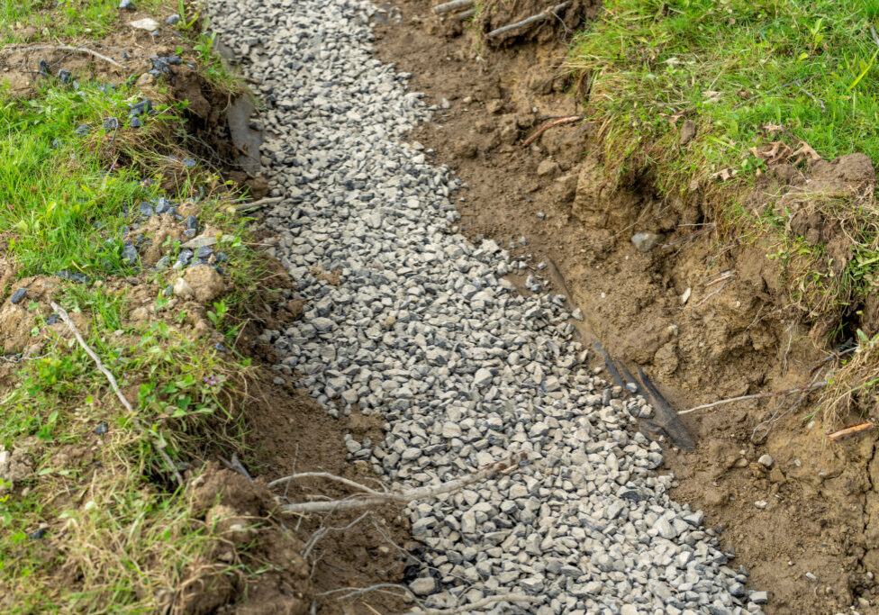 Stone French drain, under drain to mitigate storm water ground water.